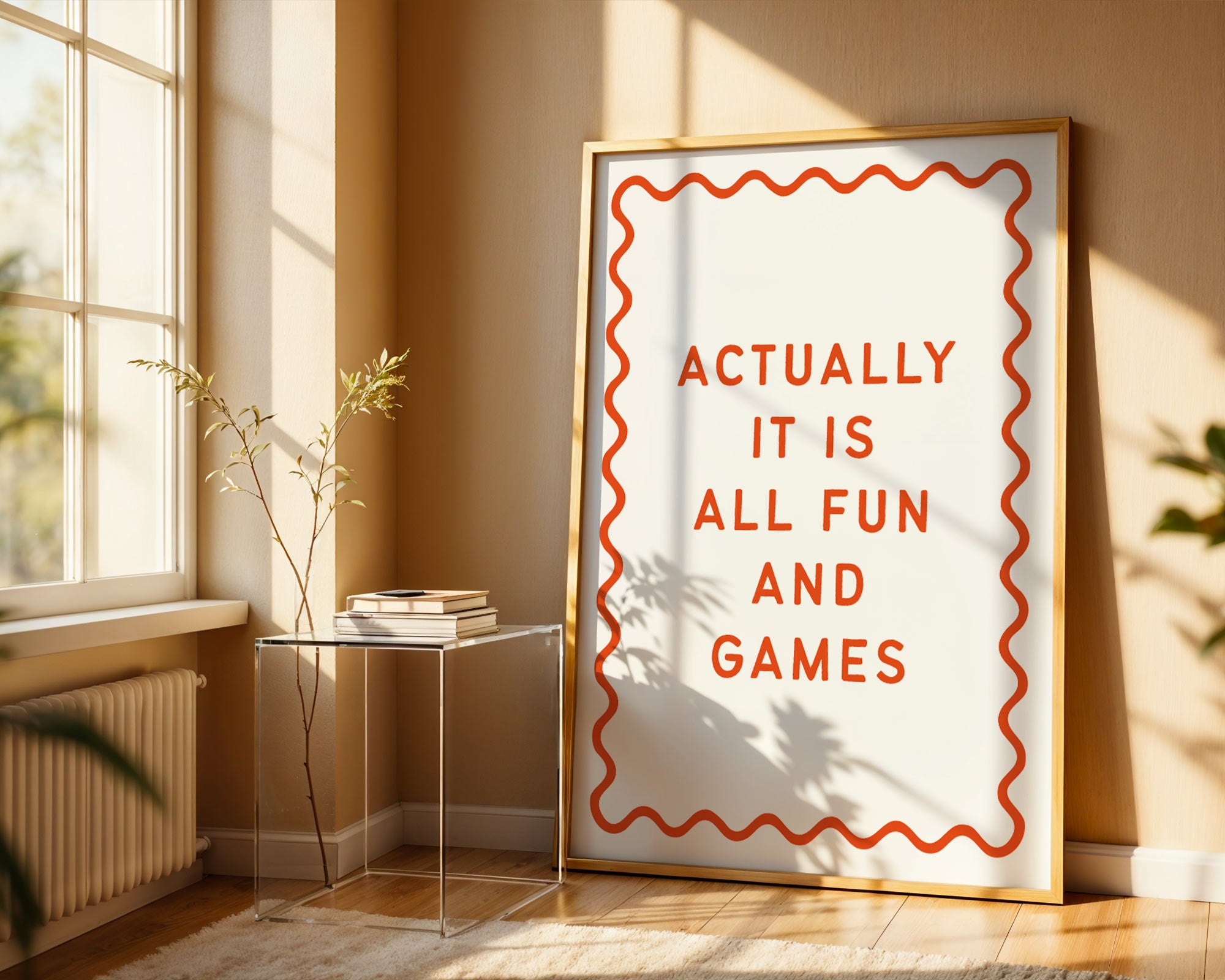 Framed poster with 'Actually it is all fun and games' text in a sunlit room.