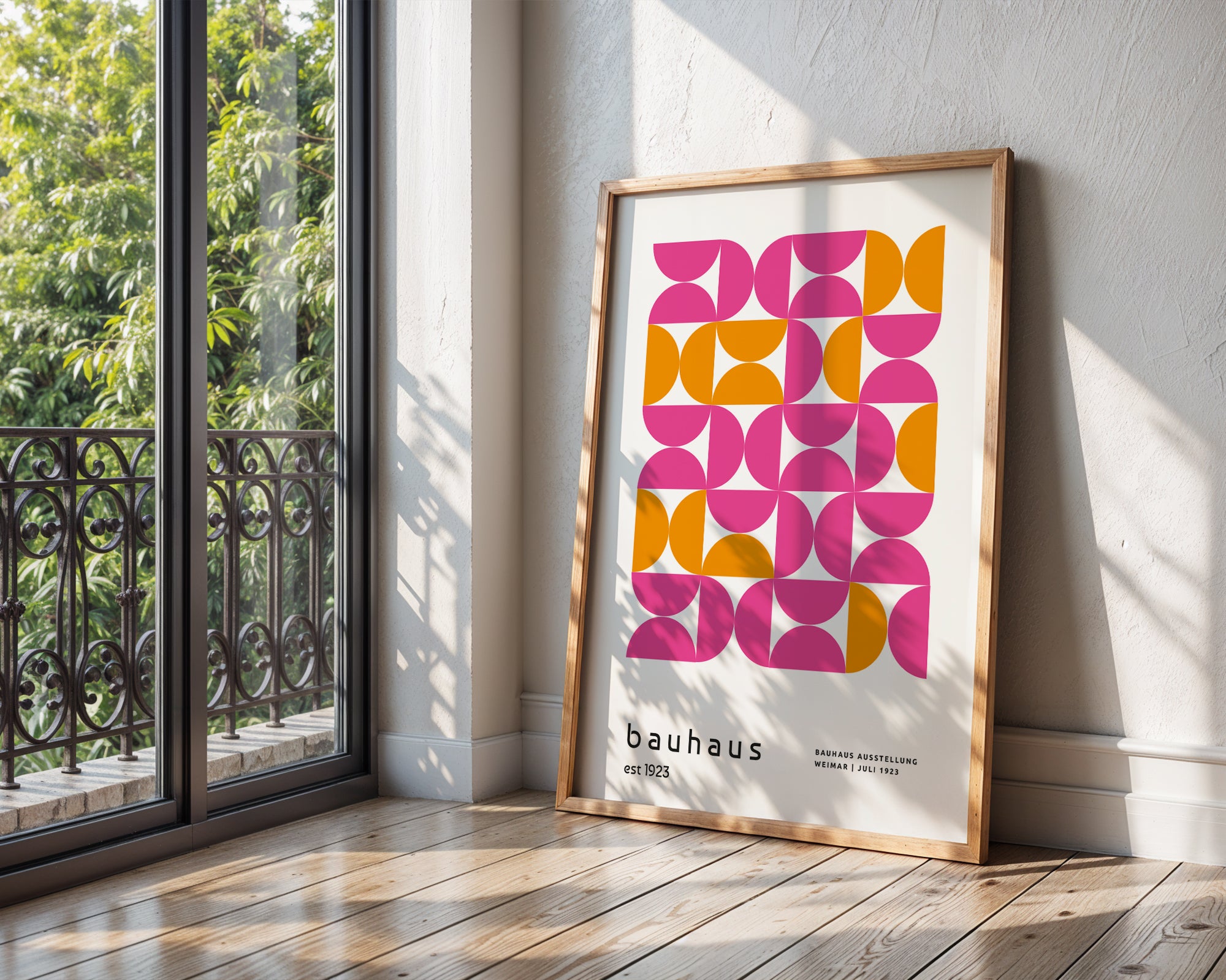 Framed Bauhaus poster with geometric design in a room with a window and wooden floor.