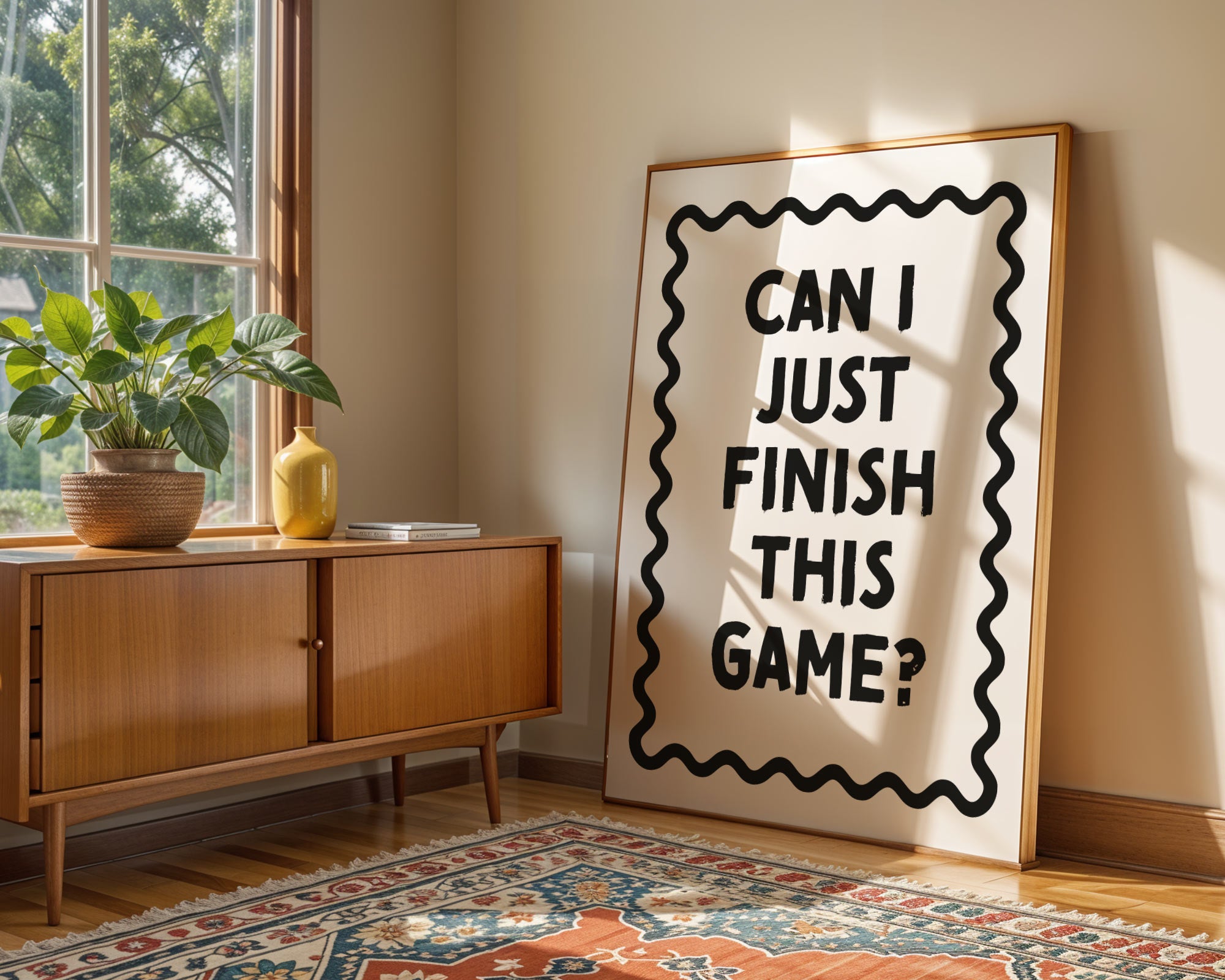 Room interior with a wooden sideboard, plant, and large framed poster with text.