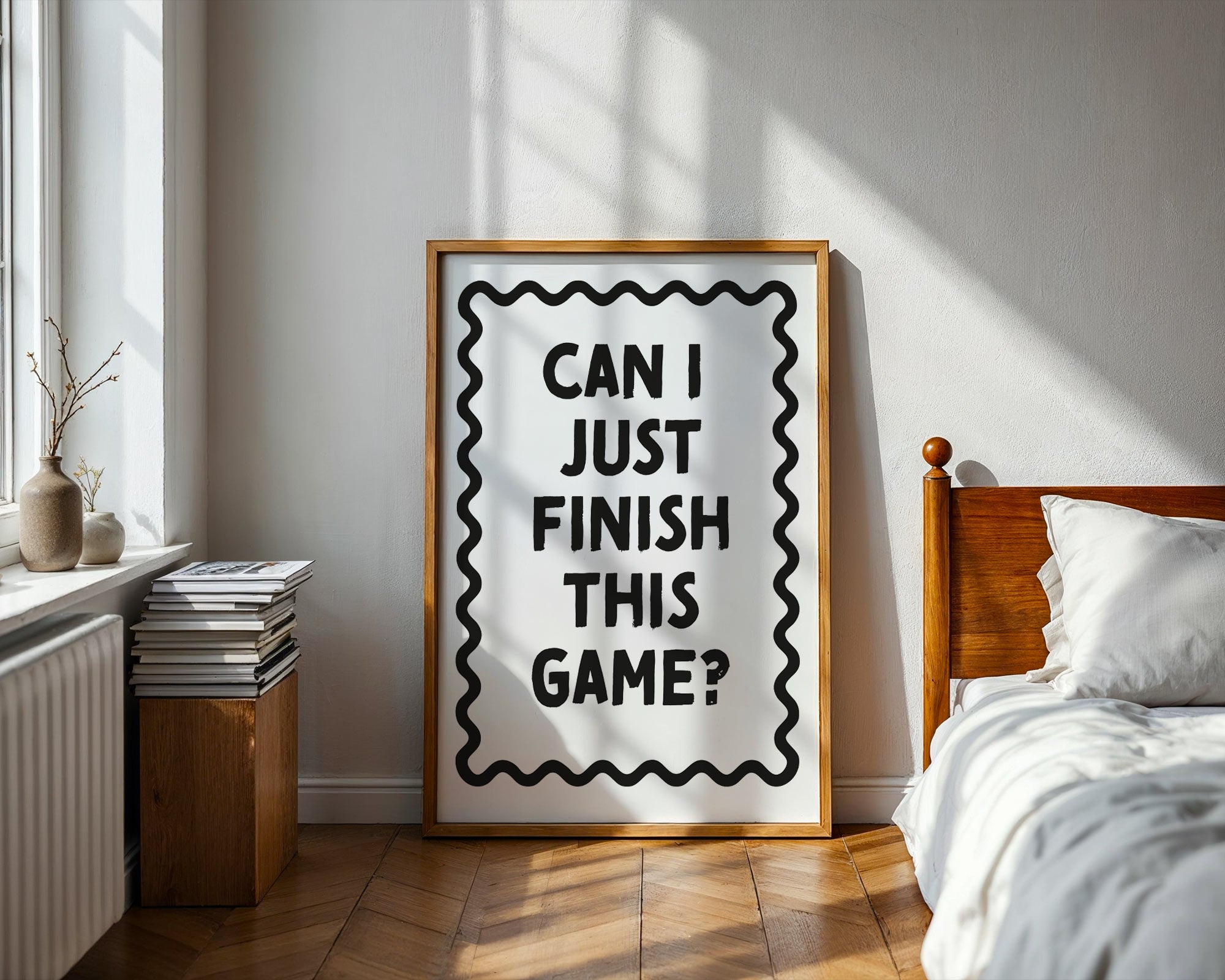 Framed poster with text 'Can I just finish this game?' in a bedroom setting.