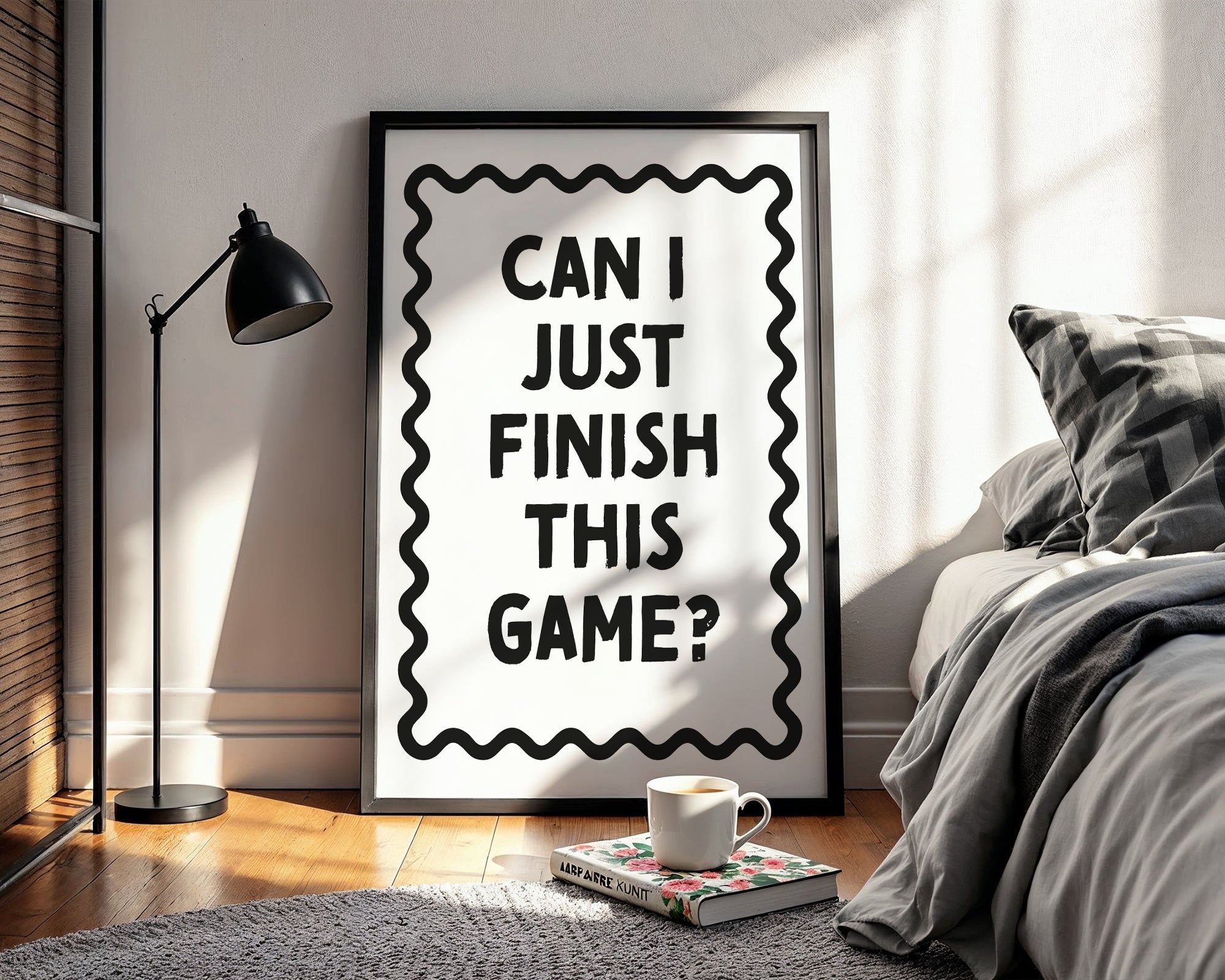 Framed poster with text 'Can I just finish this game?' in a bedroom setting.