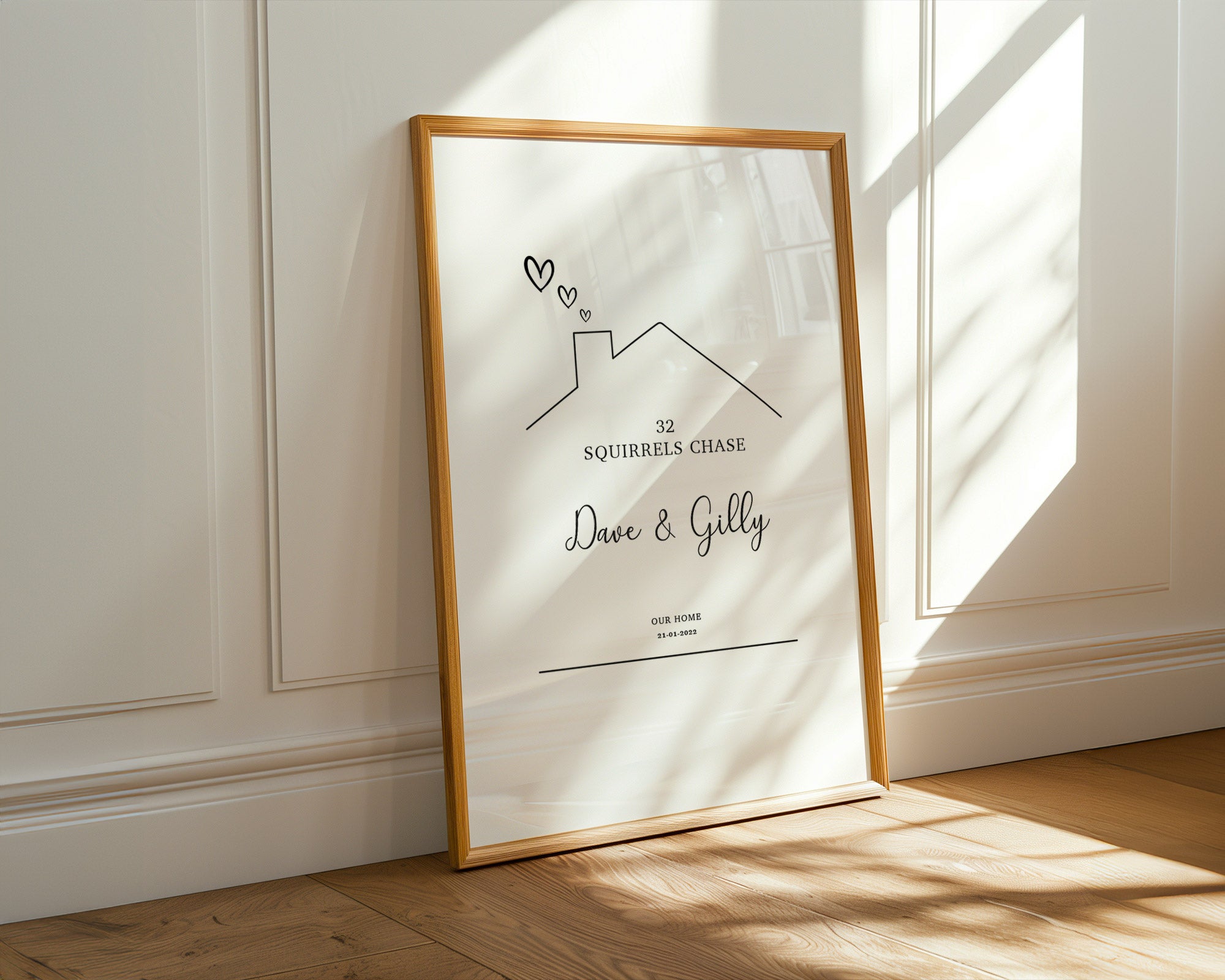 Framed artwork on a wall with sunlight casting shadows