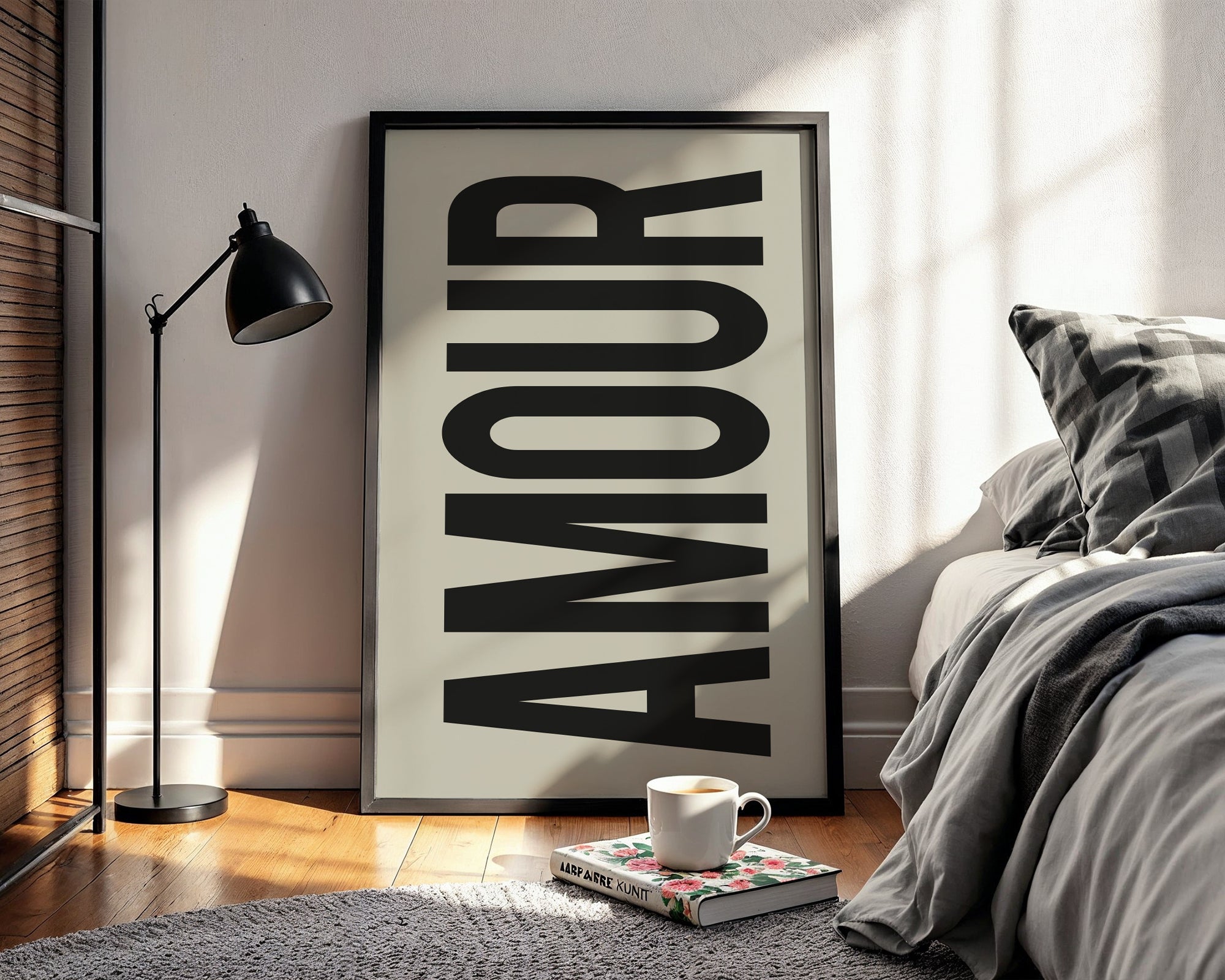 Framed artwork with the word 'AMOUR' in a bedroom setting.