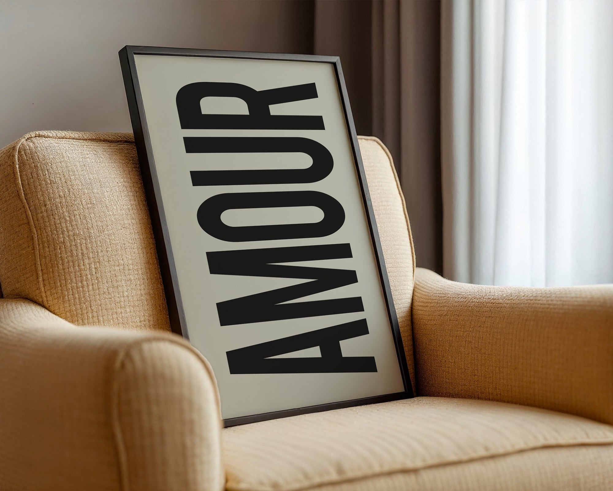 Framed artwork with the word 'AMOUR' on a beige sofa.
