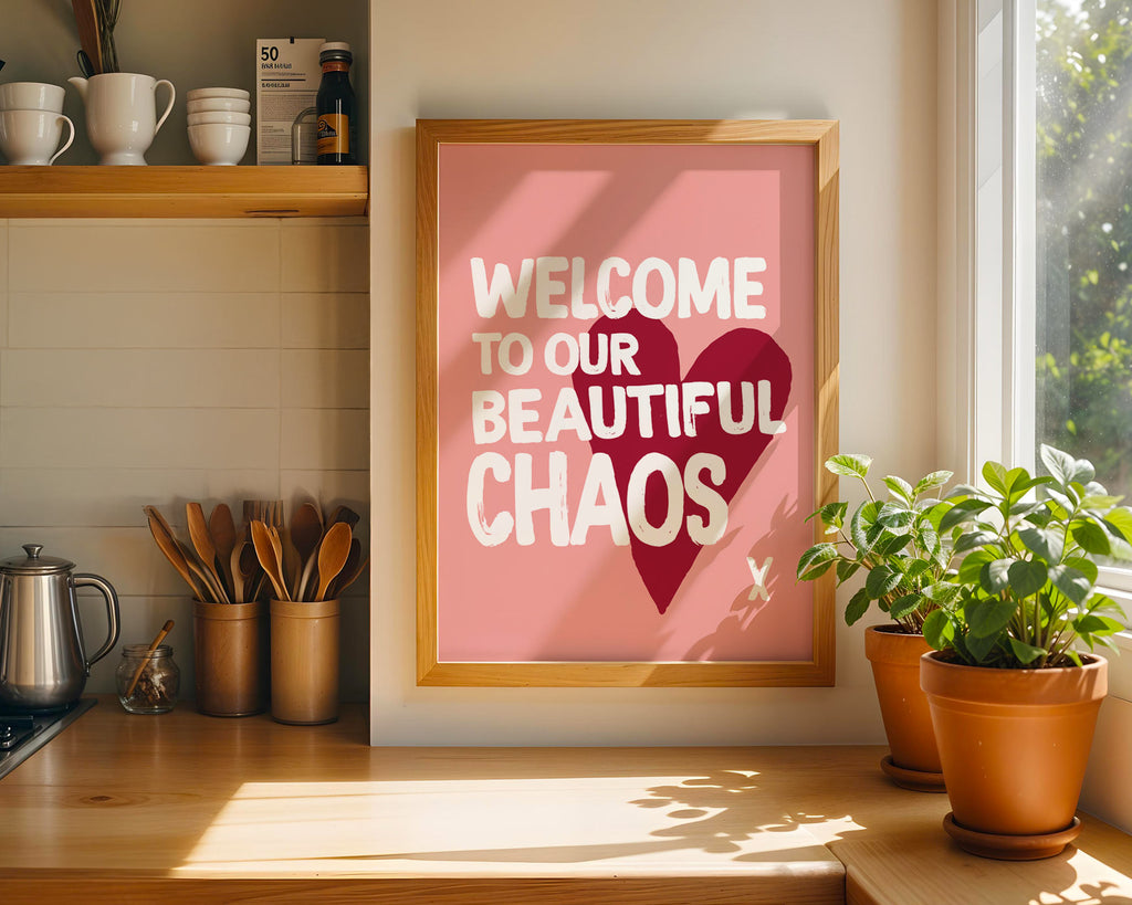 Framed print with 'Welcome to our beautiful chaos' text in a kitchen setting