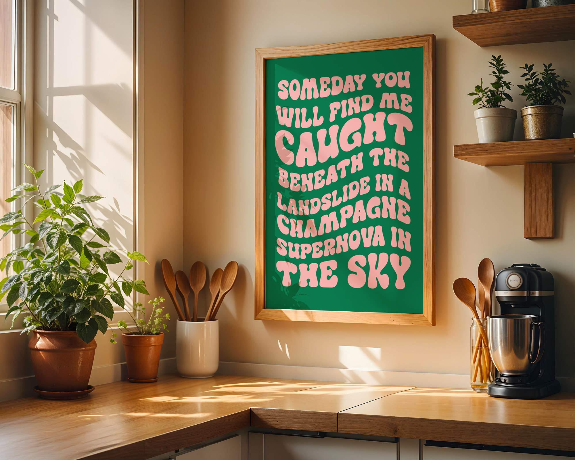Kitchen interior with a framed quote on the wall, plants, and kitchen utensils.