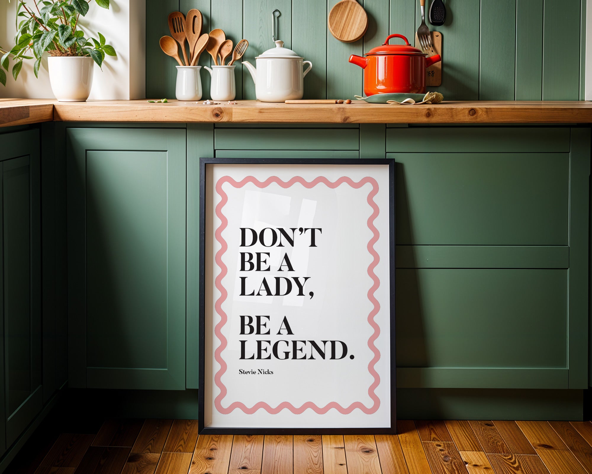 Kitchen interior with a framed quote on a green wall