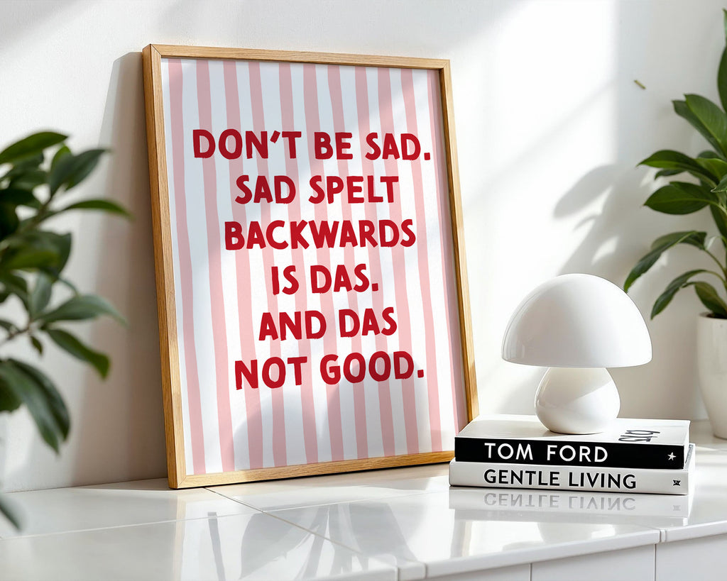 Framed poster with motivational quote on a shelf with decor items