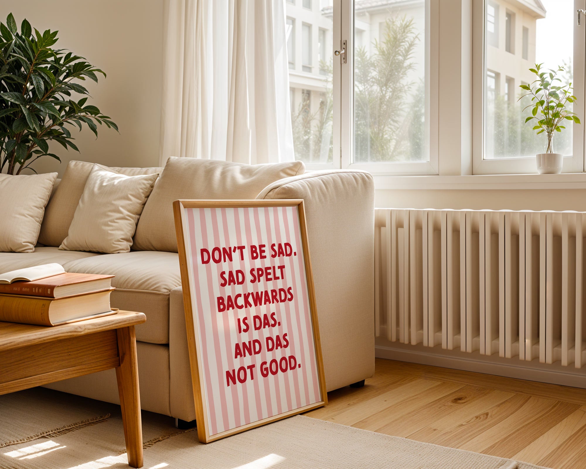 Living room with a beige sofa, wooden coffee table, and a framed sign with text.