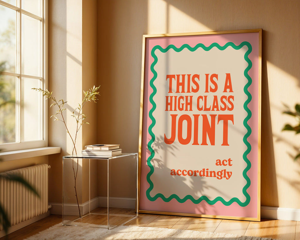 Framed poster with text 'This is a high class joint, act accordingly' in a sunlit room.