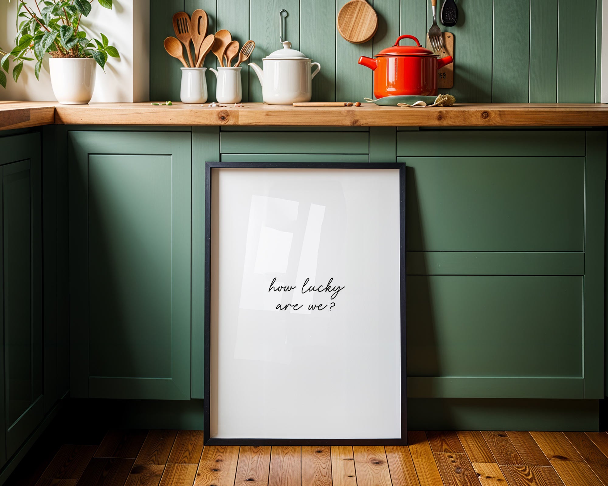 Framed print with 'how lucky are we?' text in a kitchen setting