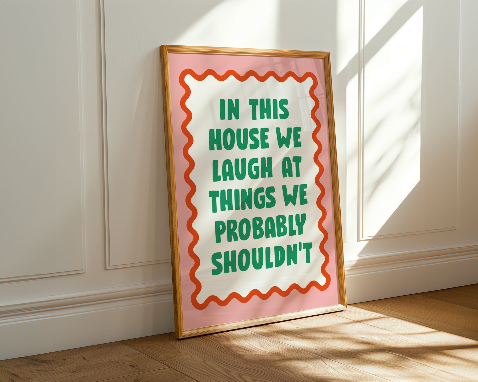 Framed poster with humorous quote on a wall in a room with sunlight streaming in.