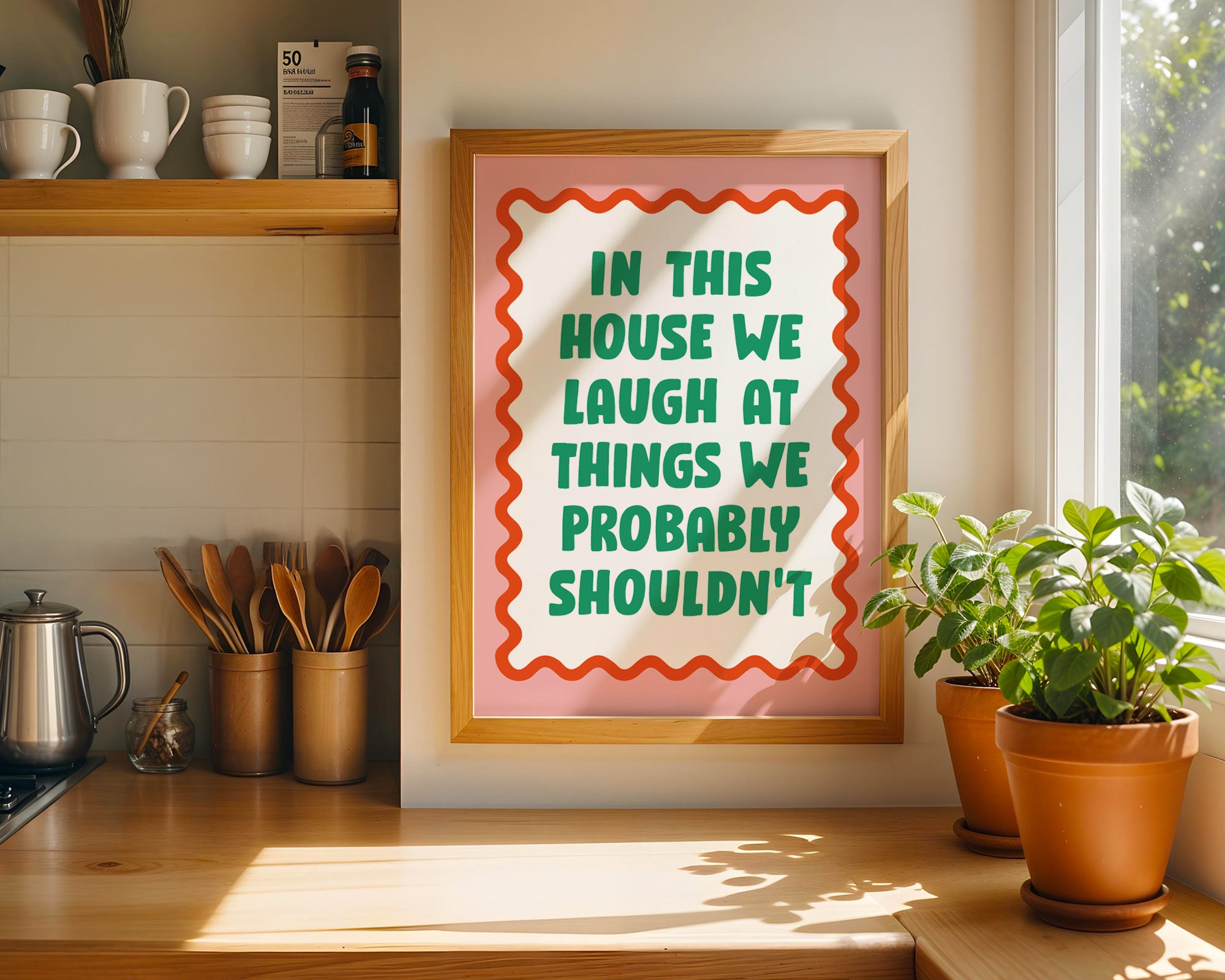 Framed poster with humorous quote in a kitchen setting