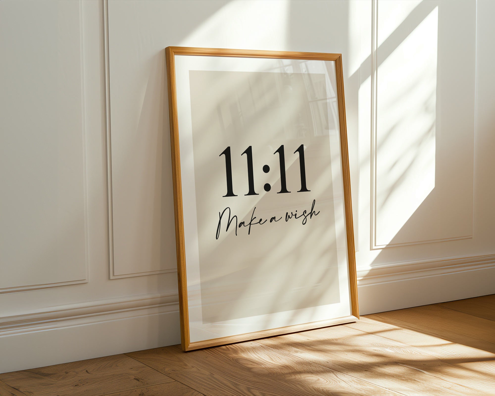Framed artwork with '11:11 Make a wish' text on a wall.