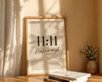 Framed artwork with '11:11 Make a wish' text on a wall with sunlight casting shadows.