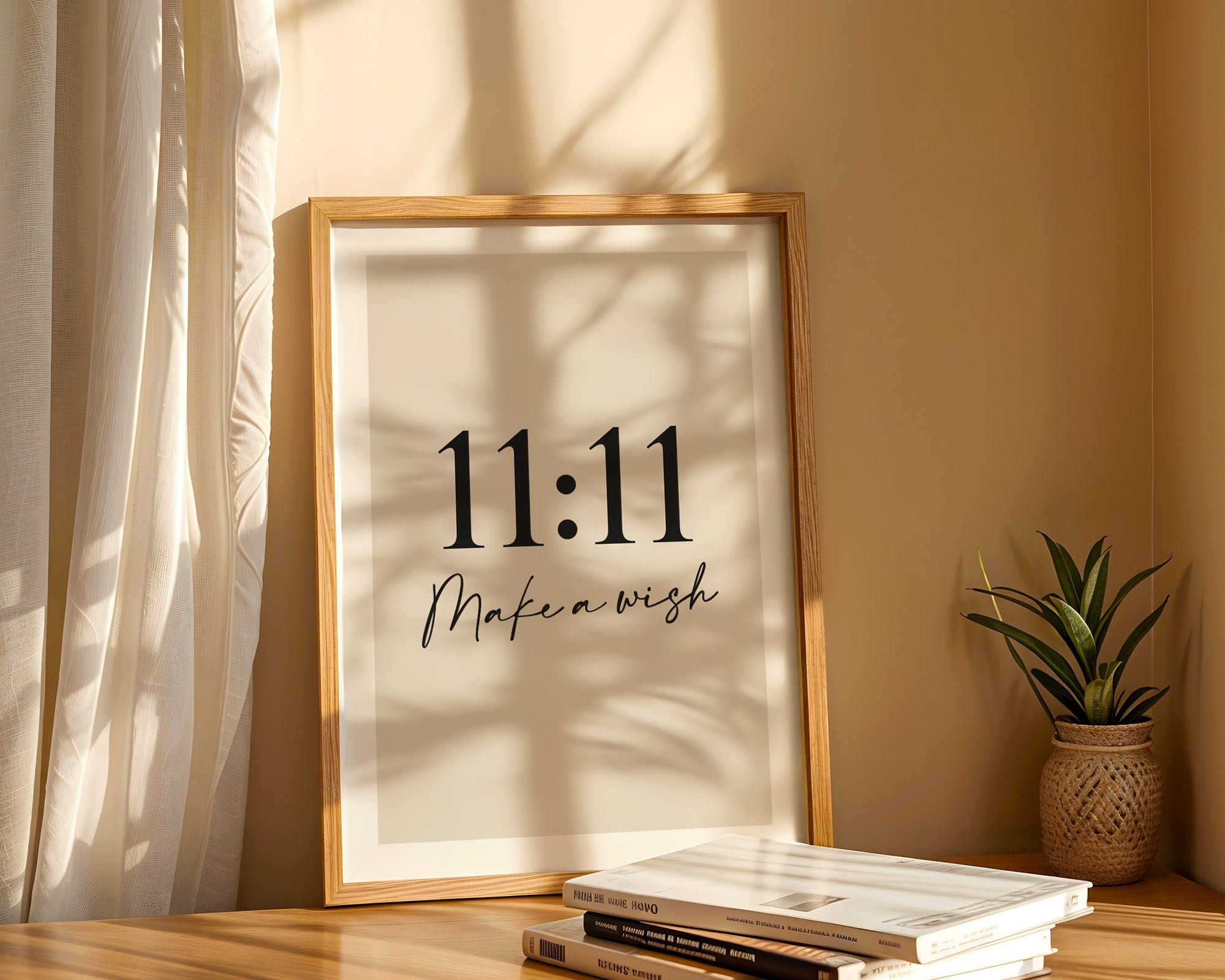 Framed artwork with '11:11 Make a wish' text on a wall with sunlight casting shadows.