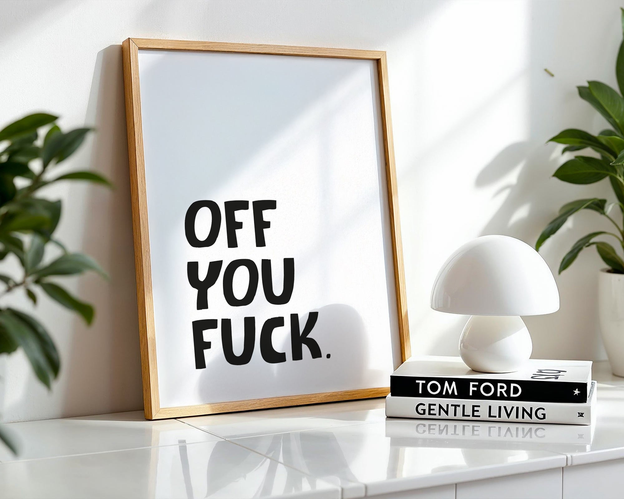 Framed artwork with text on a shelf with decor items