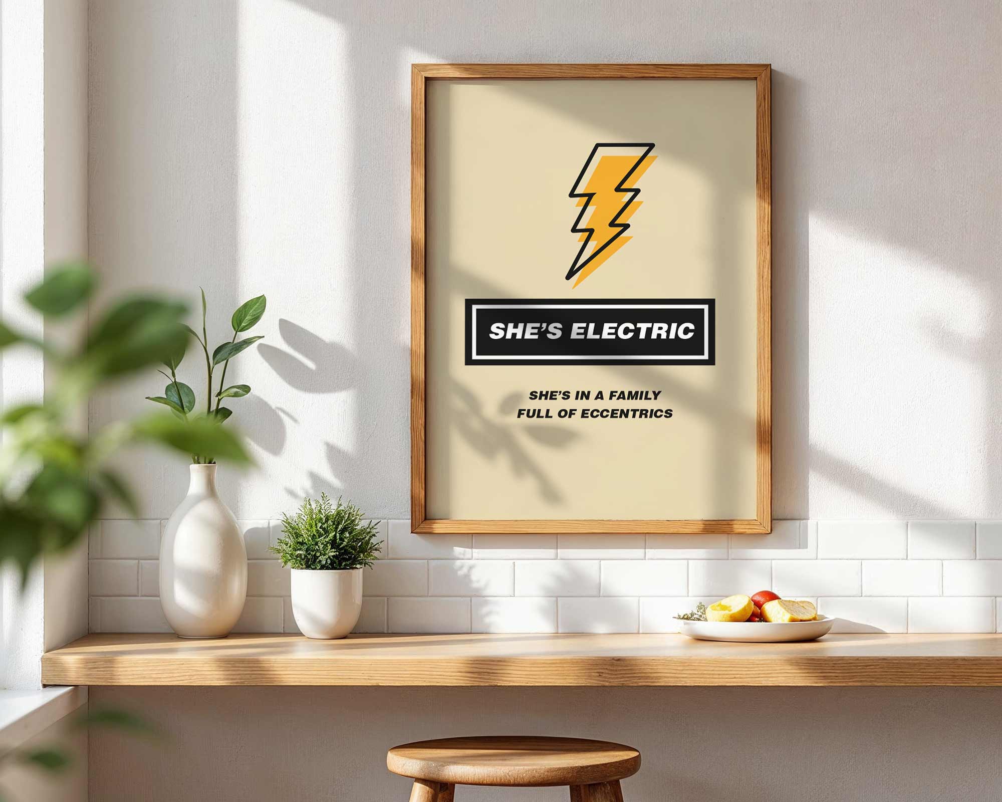Framed artwork with a lightning bolt design and text on a wall above a wooden shelf.