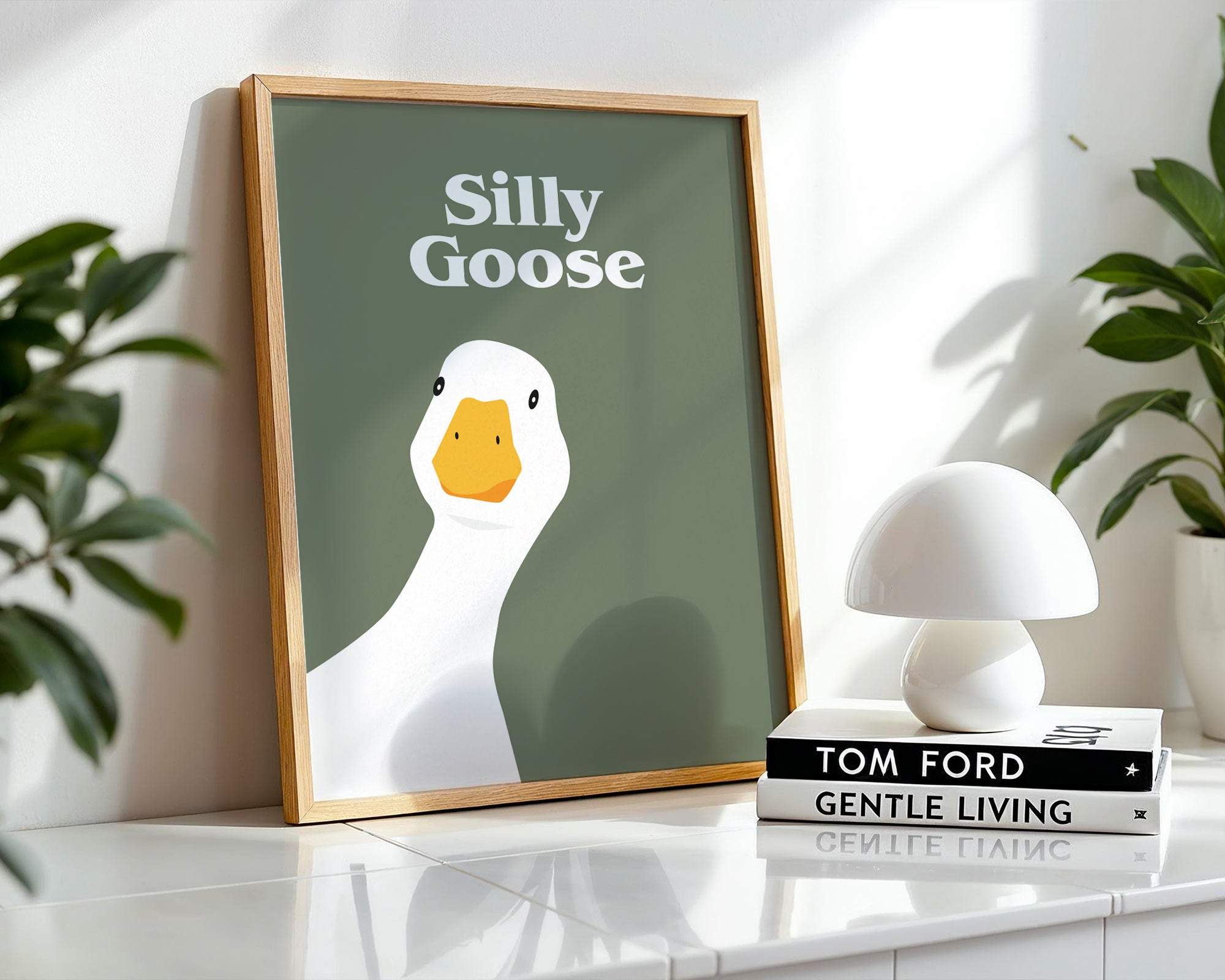 Framed artwork with a duck illustration and text on a shelf with decor items.