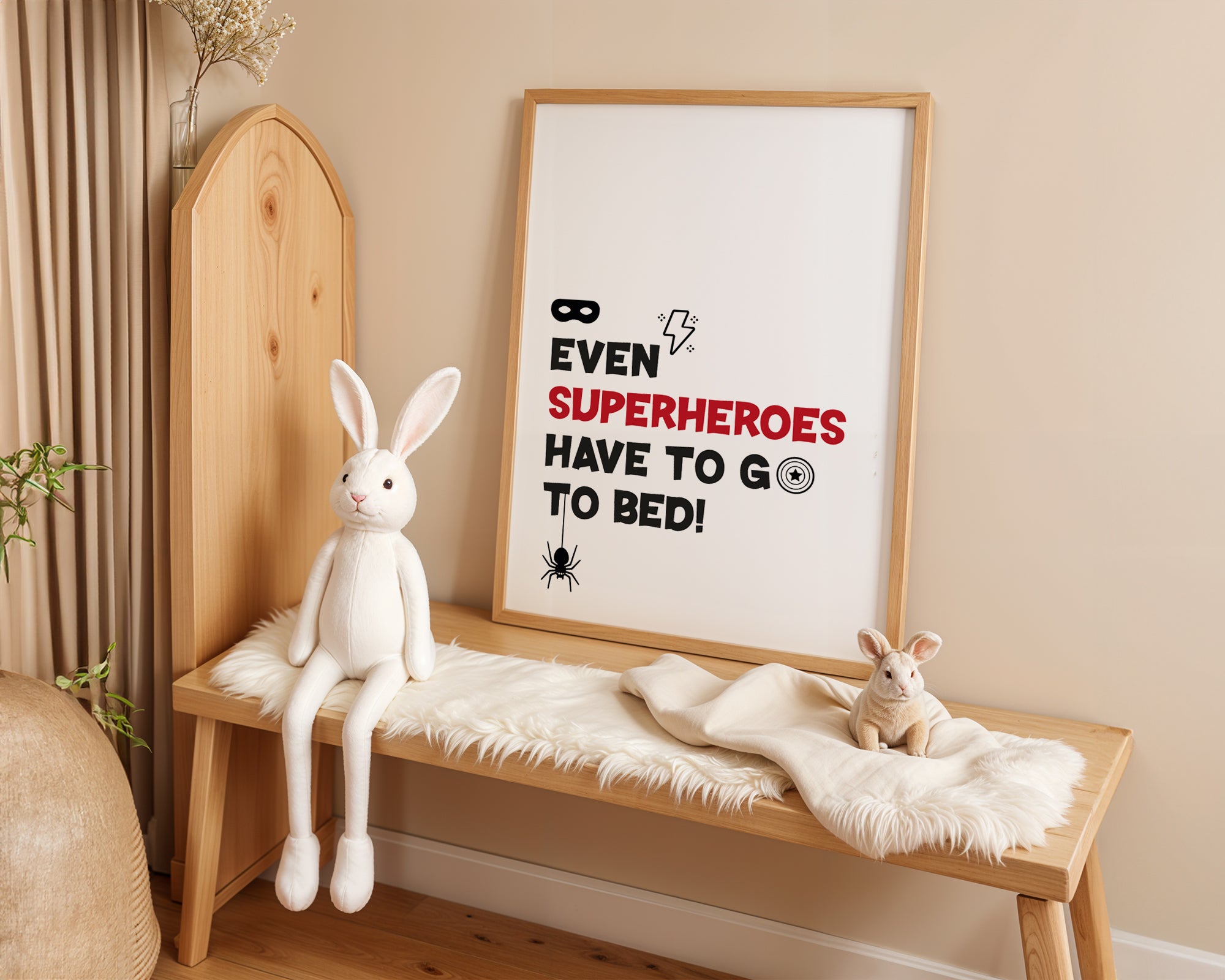 Wooden bench with plush toys and a framed poster on a beige wall