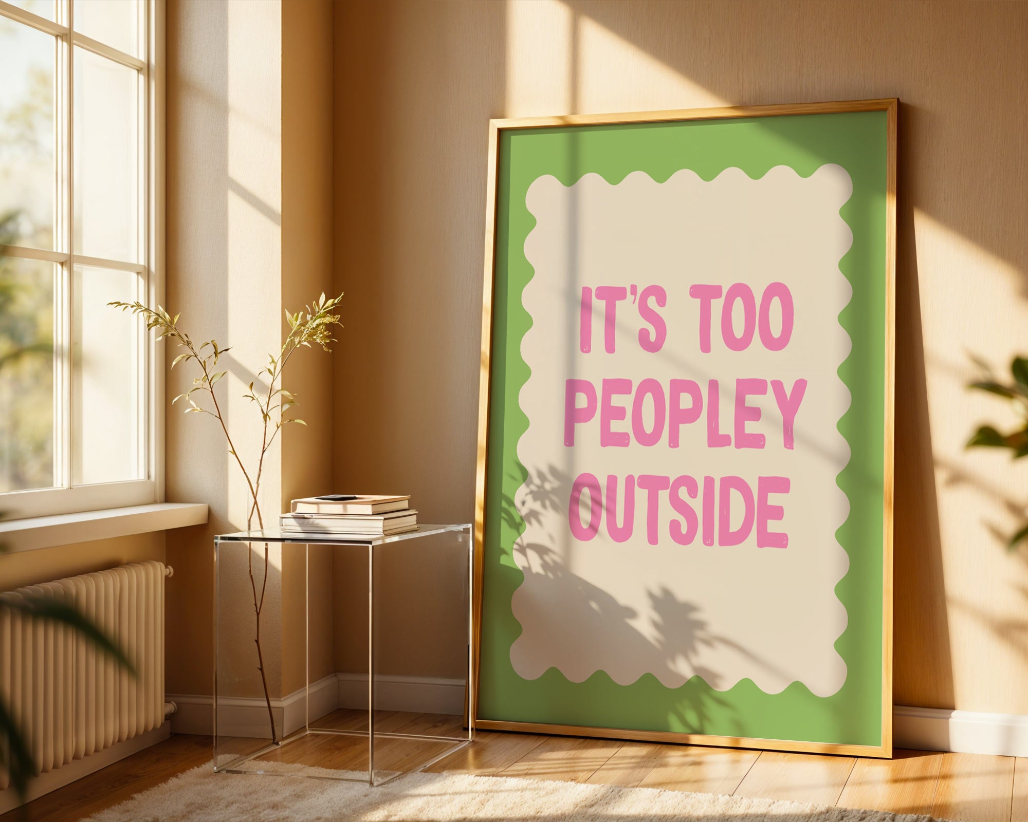 Framed poster with 'It's too peopley outside' text in a sunlit room.
