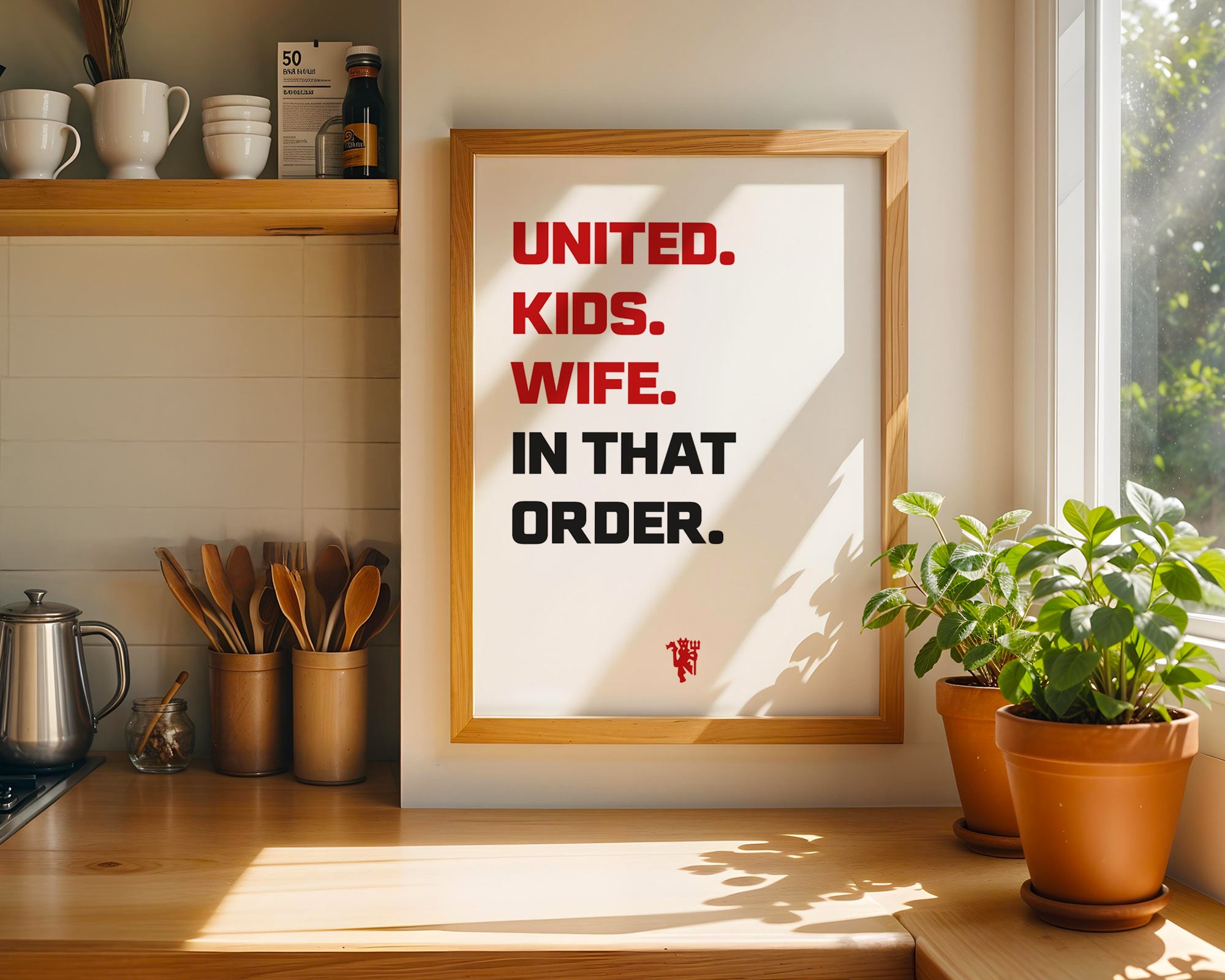 Framed poster with humorous text in a kitchen setting