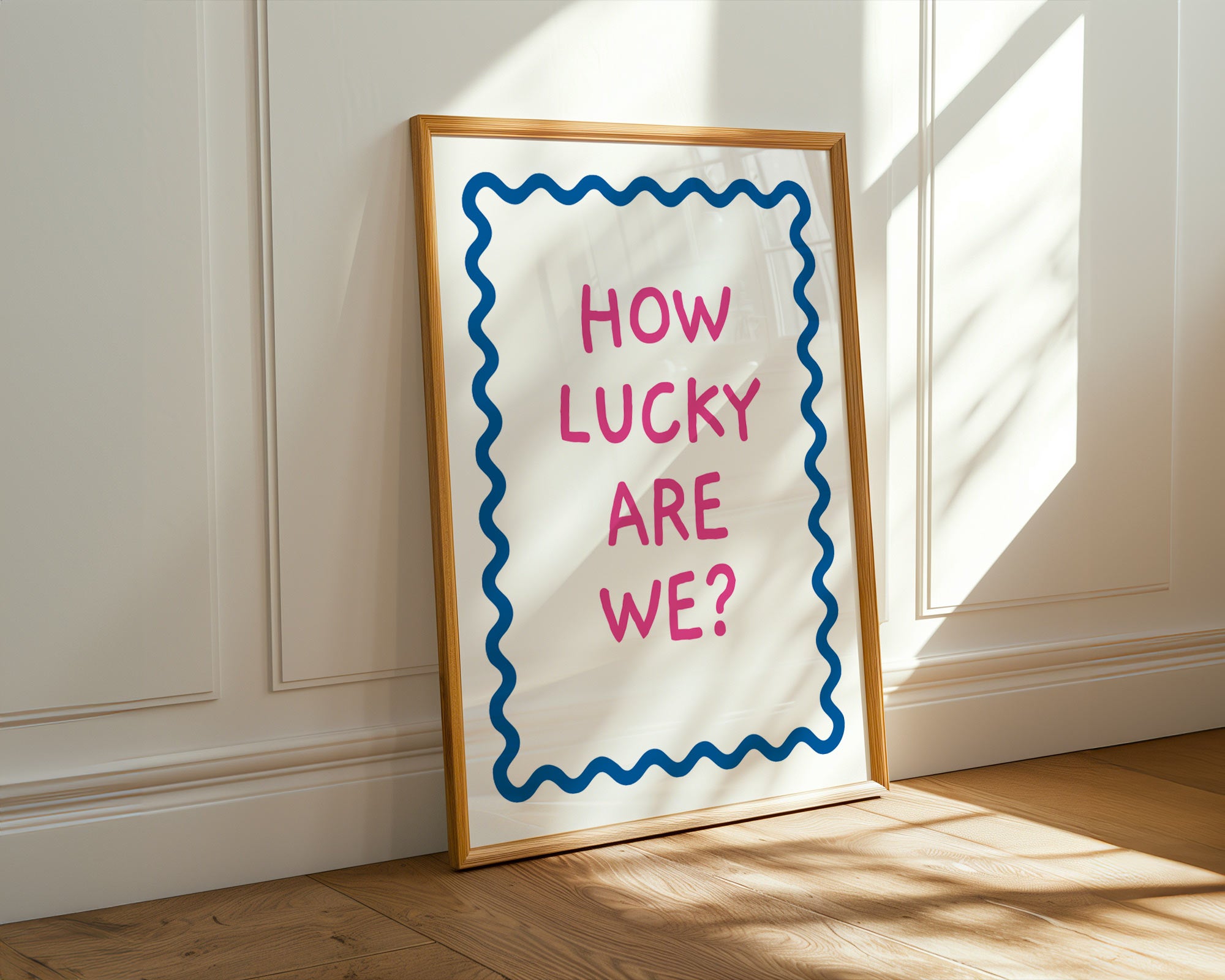 Framed poster with 'How Lucky Are We?' text on a wall.
